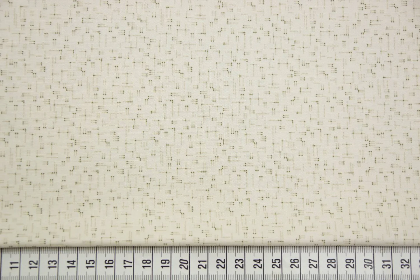 quiltstof- ecru met stipjespatroon in br.