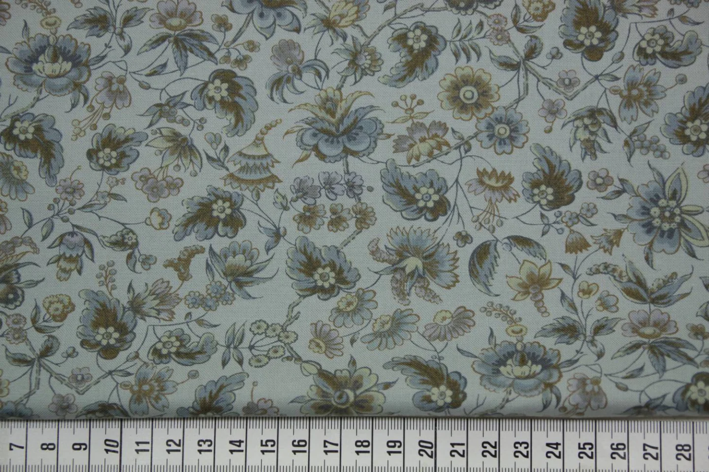 quiltstof-licht grijsblauw -bloemen aan.