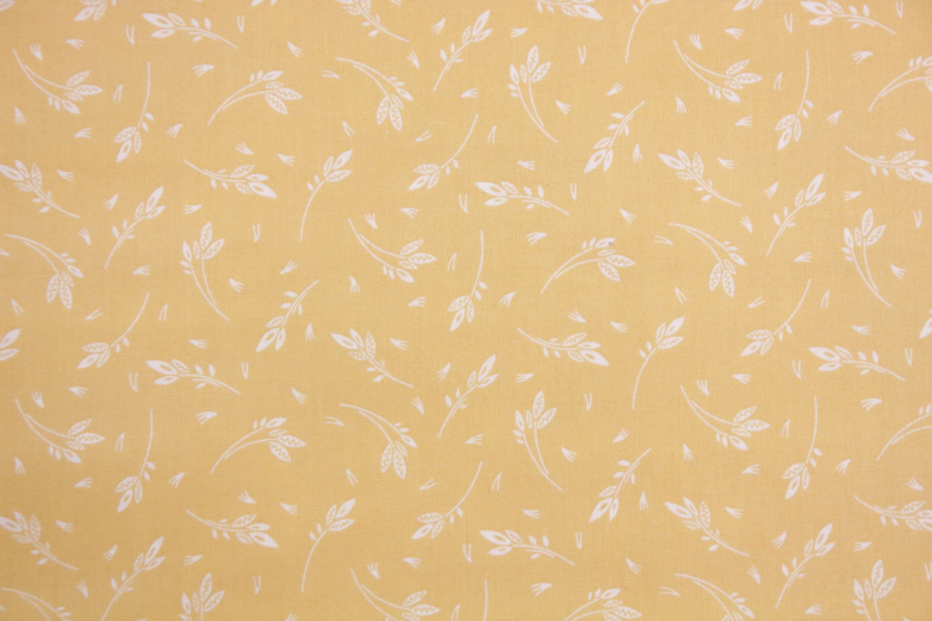 quiltstof-Licht okergeel met takjes in w