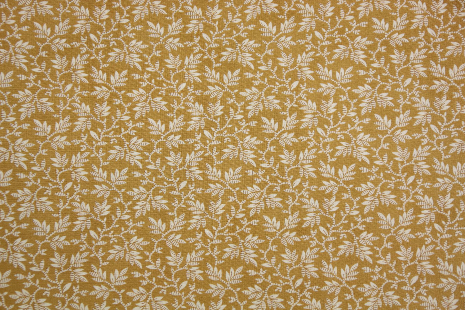 quiltstof-Donker okergeel met takjes in