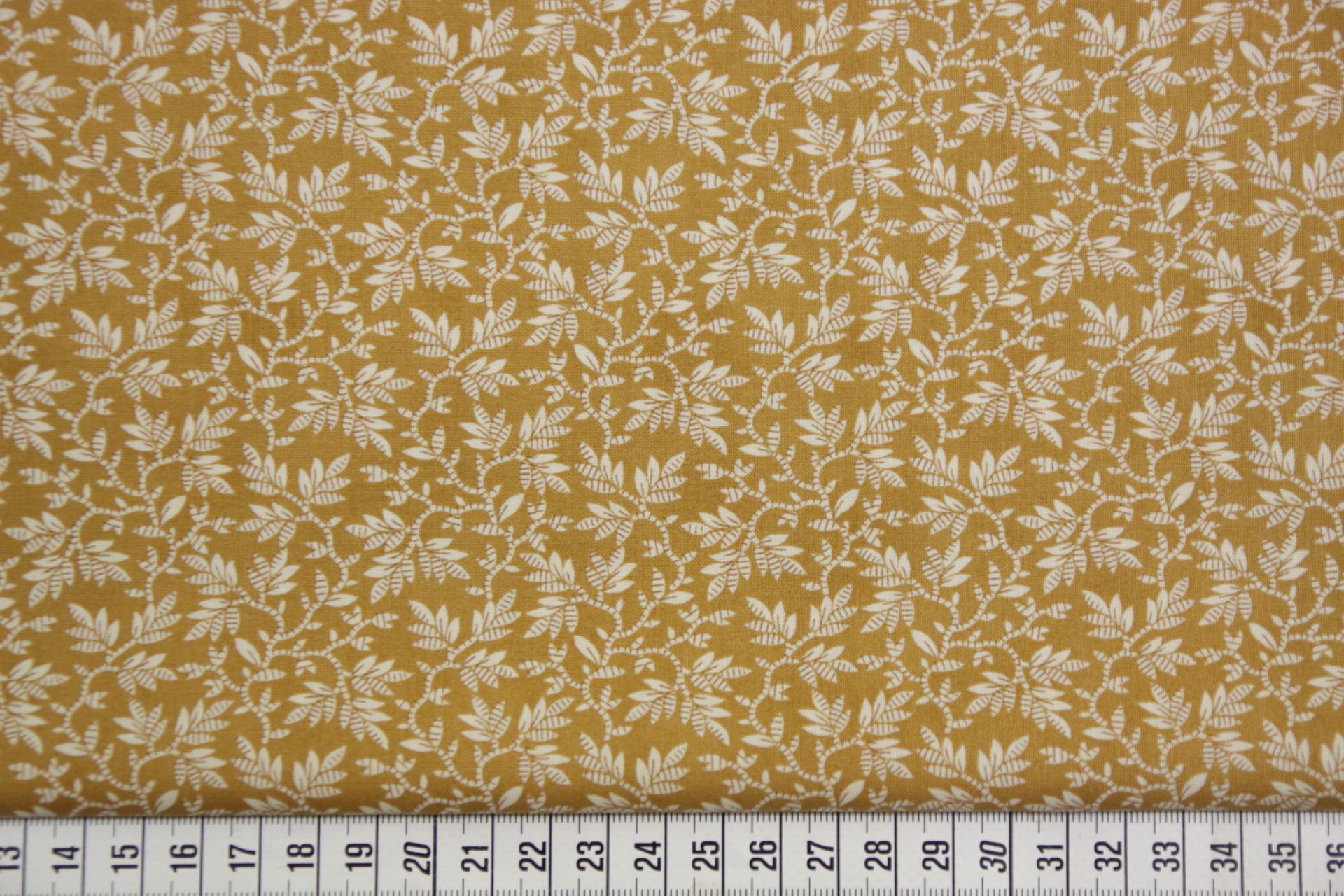 quiltstof-Donker okergeel met takjes in